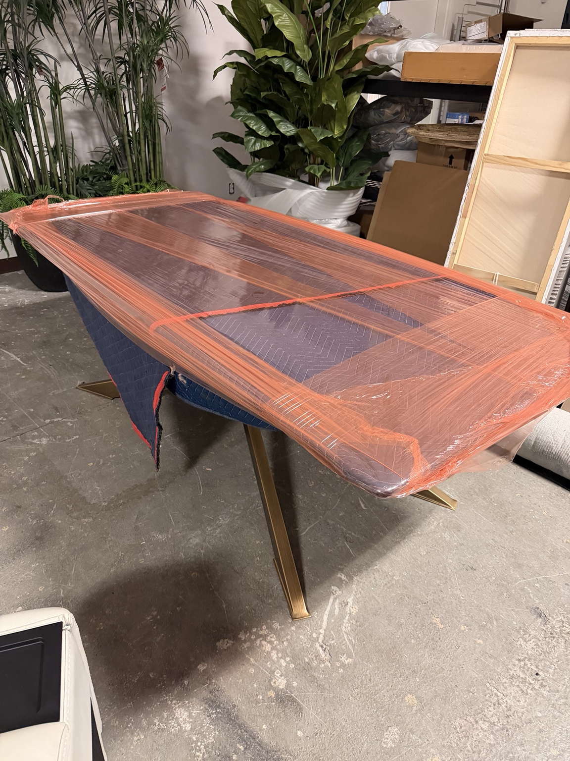 Dining table carefully protected with moving wrap and padding
